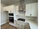 Modern kitchen featuring white cabinets, stainless steel appliances, and ample counter space at 409 Marthas View Way, Wake Forest, NC 27587