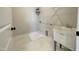 Bright laundry room with white tiled flooring, a utility sink, and a wire shelf for storage at 409 Marthas View Way, Wake Forest, NC 27587