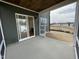 View from the screened porch showcases the dark green siding, sliding door, and concrete flooring at 409 Marthas View Way, Wake Forest, NC 27587
