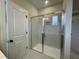 Glass shower with marble-look tile and a built-in niche at 409 Marthas View Way, Wake Forest, NC 27587