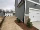 This home features an attached two-car garage and stone accents at 409 Marthas View Way, Wake Forest, NC 27587