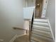 Wooden staircase features white risers and a black metal railing, leading to the lower and upper floors at 409 Marthas View Way, Wake Forest, NC 27587