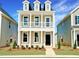 Charming two-story home featuring a quaint front yard and a lovely second-floor balcony with white railings at 50 Blue Iris Pkwy # 122, Clayton, NC 27520