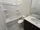 Clean bathroom features a shower-tub combo, toilet, and vanity with ample lighting at 6044 Scalybark Road, Durham, NC 27712