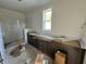 Bathroom featuring double vanities, cabinets and a tiled shower at 6044 Scalybark Road, Durham, NC 27712