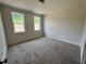 Bedroom featuring plush carpeting and natural light from double-hung windows at 6044 Scalybark Road, Durham, NC 27712