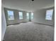 A spacious bedroom with plush carpeting and natural light from double-hung windows at 6044 Scalybark Road, Durham, NC 27712
