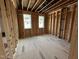 Bright bedroom featuring two windows and wood framing at 6044 Scalybark Road, Durham, NC 27712