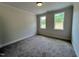 Bedroom featuring plush carpeting and natural light from double-hung windows at 6044 Scalybark Road, Durham, NC 27712