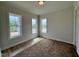 Bright bedroom with three large windows offering a view of the outdoors at 6044 Scalybark Road, Durham, NC 27712