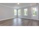 Bright bedroom features wood floors, three large windows, recessed lighting, and white trim at 6044 Scalybark Road, Durham, NC 27712