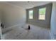 Bright bedroom featuring natural light from two windows and neutral color palette at 6044 Scalybark Road, Durham, NC 27712