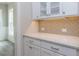 White cabinetry and herringbone backsplash in butlers pantry at 6044 Scalybark Road, Durham, NC 27712