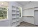 Walk-in closet with custom shelving, wood floors, and natural light from the large window at 6044 Scalybark Road, Durham, NC 27712