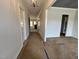 Spacious hallway leads to various rooms with neutral paint, crown moulding, and elegant lighting at 6044 Scalybark Road, Durham, NC 27712