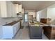 Spacious kitchen features white cabinets, a large island, and ample counter space at 6044 Scalybark Road, Durham, NC 27712