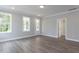 Light-filled living room with hardwood floors and access to a deck at 6044 Scalybark Road, Durham, NC 27712