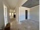 Bright and airy living room features elegant ceiling detail, light gray walls, and multiple windows at 6044 Scalybark Road, Durham, NC 27712