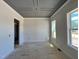 Bright living room features light gray walls, white trim, and large windows at 6044 Scalybark Road, Durham, NC 27712