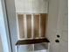 Mudroom with storage bench, shelving, and cabinets near the entry, perfect for organization at 6044 Scalybark Road, Durham, NC 27712