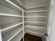 View of pantry with custom built in shelving and wood floors at 6044 Scalybark Road, Durham, NC 27712