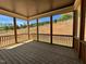 Covered patio area with wooden flooring, and views of the surrounding landscape at 6044 Scalybark Road, Durham, NC 27712