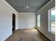 Well-lit room with a decorative tray ceiling and large windows offering natural light at 6044 Scalybark Road, Durham, NC 27712