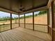 Inviting screened-in porch with wood flooring and a ceiling fan for relaxation and outdoor enjoyment at 6044 Scalybark Road, Durham, NC 27712