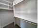 Walk-in closet featuring custom shelving and rods at 6044 Scalybark Road, Durham, NC 27712