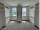 Walk-in closet featuring custom shelving and natural light from window at 6044 Scalybark Road, Durham, NC 27712
