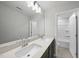 Bathroom featuring double sink vanity with quartz countertop, large mirror, and tile flooring at 77 Buckhorn Branch Park # 174, Clayton, NC 27520