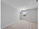 Bedroom featuring neutral carpet, window view, and light gray painted walls at 77 Buckhorn Branch Park # 174, Clayton, NC 27520