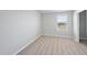 Bedroom featuring neutral carpet, window view, and light gray painted walls at 77 Buckhorn Branch Park # 174, Clayton, NC 27520