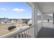Front porch with black car in driveway and picturesque neighborhood view at 77 Buckhorn Branch Park # 174, Clayton, NC 27520