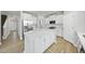 Bright kitchen boasts white cabinets, stainless steel appliances, and a large island with bar seating at 77 Buckhorn Branch Park # 174, Clayton, NC 27520
