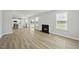 Spacious open concept living room showcasing hardwood floors, a cozy fireplace, and a view of the modern kitchen at 77 Buckhorn Branch Park # 174, Clayton, NC 27520