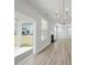 Bright living room with hardwood floors, elegant chandelier, fireplace and access to the patio at 77 Buckhorn Branch Park # 174, Clayton, NC 27520