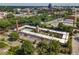 Aerial view showcases a complex with a central pool, gardens, surrounding cityscape, and ample parking at 807 W Trinity Ave # 220, Durham, NC 27701