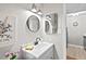 Bathroom featuring updated vanity with sink, decorative mirrors, and entry view to kitchen at 807 W Trinity Ave # 220, Durham, NC 27701