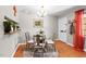 Cozy dining area features a glass table and a hanging light fixture at 807 W Trinity Ave # 220, Durham, NC 27701