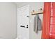 An entryway with a coat rack and red curtains, next to the front door at 807 W Trinity Ave # 220, Durham, NC 27701