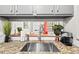 Close up of the kitchen sink featuring granite countertops, open pass through, and stainless steel faucet at 807 W Trinity Ave # 220, Durham, NC 27701