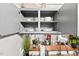 Kitchen with open cabinets and a pass through to the living area and natural light at 807 W Trinity Ave # 220, Durham, NC 27701