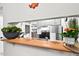 A view of a kitchen with stainless steel appliances through the pass-through at 807 W Trinity Ave # 220, Durham, NC 27701