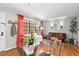 The living room features a leather couch, red curtains and lots of natural light at 807 W Trinity Ave # 220, Durham, NC 27701