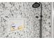 Close up of shower featuring decorative tiles and black shower head at 807 W Trinity Ave # 220, Durham, NC 27701