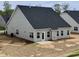 New home backyard featuring a concrete patio, dark roof, and neutral siding at 1060 Fairhaven Dr # 96, Mebane, NC 27302