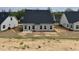 New home backyard featuring a concrete patio, dark roof, and neutral siding at 1060 Fairhaven Dr # 96, Mebane, NC 27302