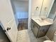 Well-lit bathroom with granite countertop, gray vanity, and tile flooring at 1060 Fairhaven Dr # 96, Mebane, NC 27302