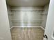 Large, empty walk-in closet with carpet floors and several wire shelves at 1060 Fairhaven Dr # 96, Mebane, NC 27302